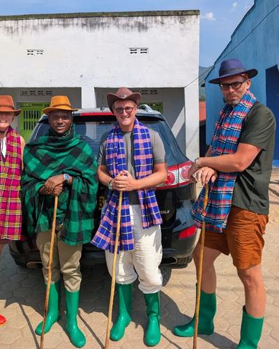 Kitted out for the trek: walking sticks, rain boots and traditional wraps — Volcano Peaks Safaris Rwanda guests