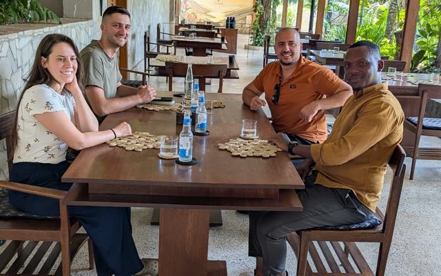 Cold drinks and stories after a day in the parks — Volcano Peaks Safaris Rwanda guests