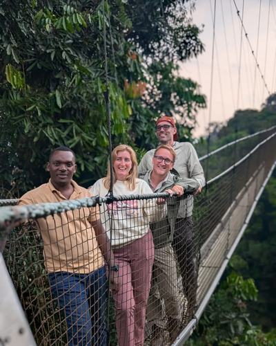 Crossing the suspension bridge on the Nyungwe canopy walk — Volcano Peaks Safaris Rwanda guests