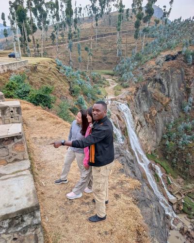 Stopping at a roadside waterfall in Rwanda’s hills — Volcano Peaks Safaris Rwanda guests